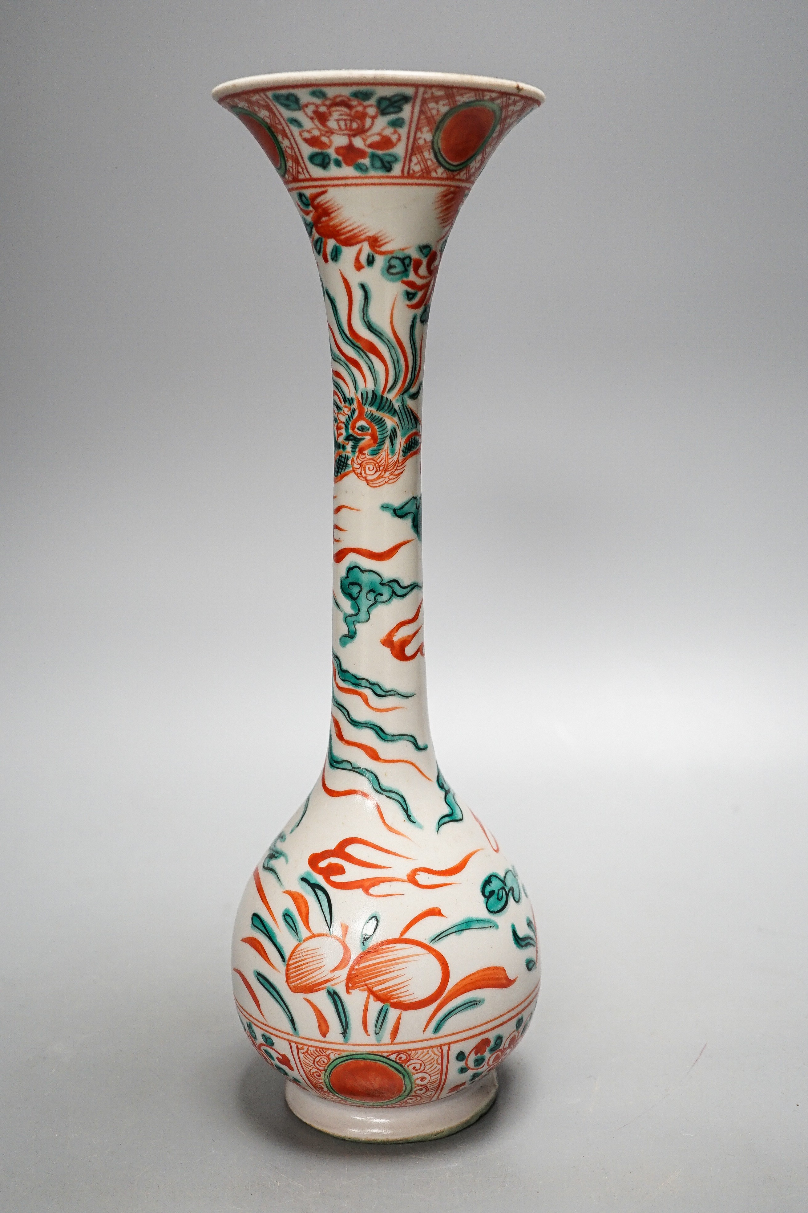 A Chinese Swatow style bottle vase, painted in green and iron red enamels with phoenixes amid flowers and clouds, 31.5cm